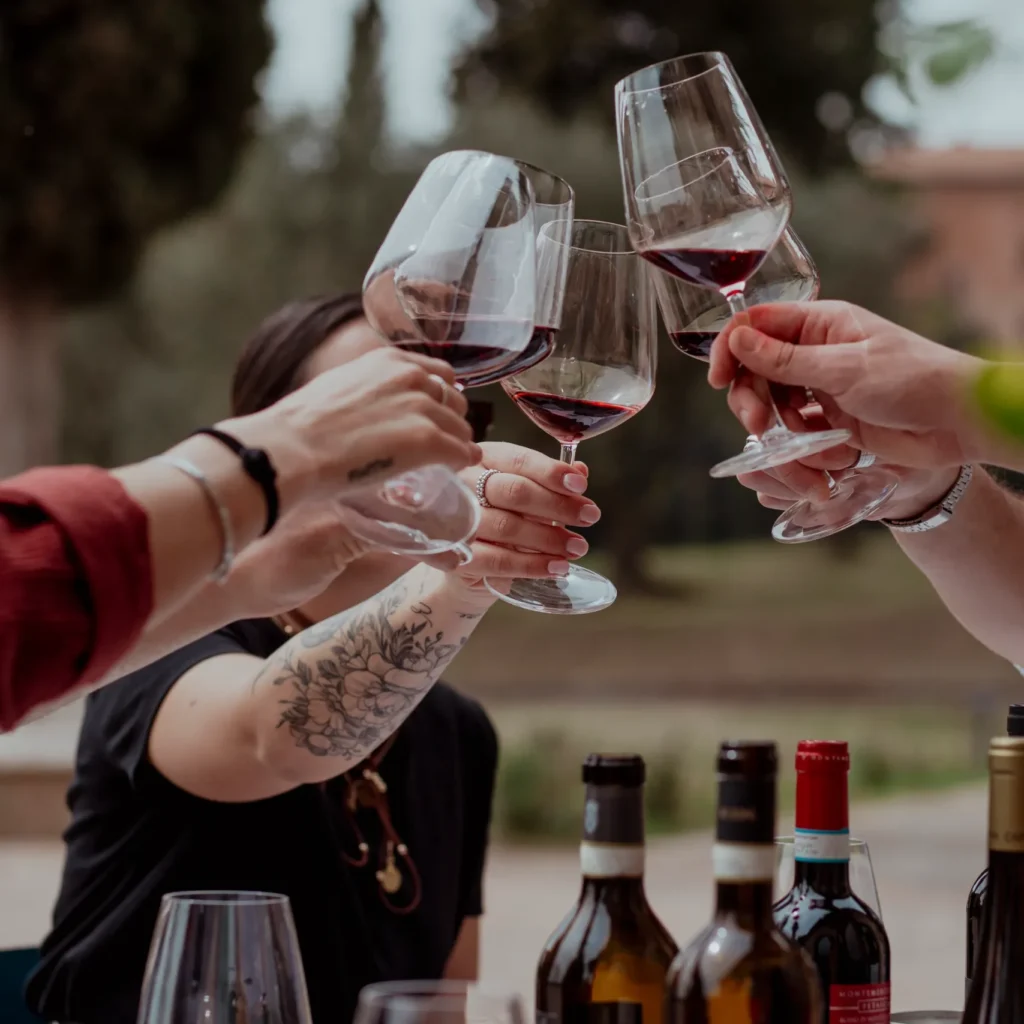 People toasting with wine during a private dining experience in Tuscany